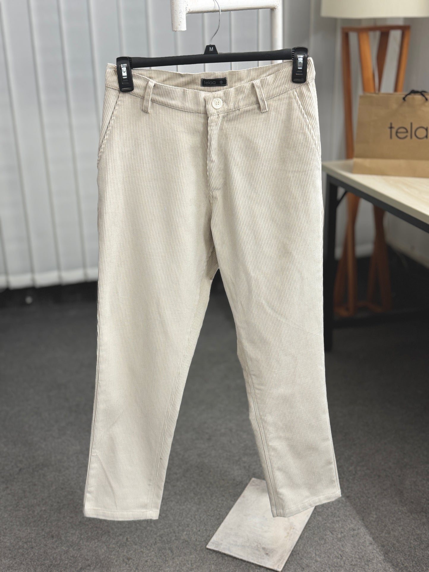 Beige pants on a hanger with a blurred background