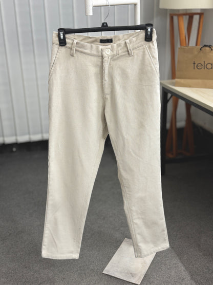 Beige pants on a hanger with a blurred background