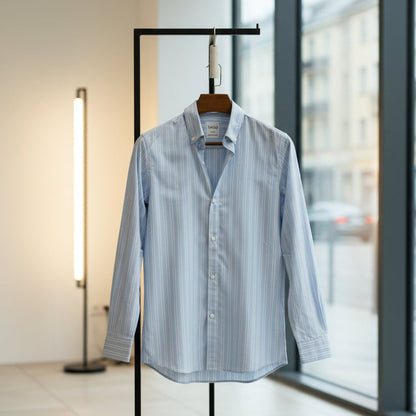 Blue striped shirt on a hanger in front of a window